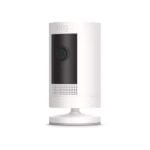 Ring Stick Up Camera with a sleek black cylindrical design, mounted on a patio wall, capturing clear HD video. The camera is shown with motion detection and live-view capabilities, highlighting its wireless installation and compatibility with Alexa for voice-activated home security.