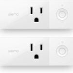 Wemo Smart Plug with a sleek, compact white design, plugged into a wall outlet in a modern kitchen, controlling a coffee maker. The smart plug highlights its Wi-Fi connectivity and compatibility with Alexa, Google Assistant, and Apple HomeKit for hands-free smart home control.