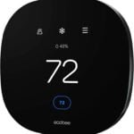 Ecobee Smart Thermostat with a sleek black square design and a bright digital touchscreen display, mounted on a wall in a modern home. The display shows current room temperature and energy-saving settings, emphasizing the thermostat's advanced smart home integration and voice control capabilities through Alexa.