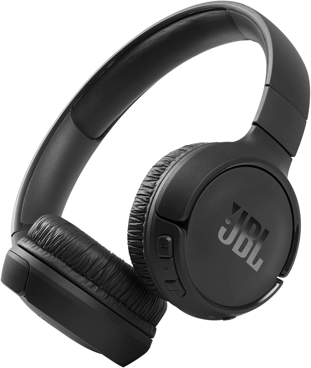 JBL Tune 510BT wireless headphones with a sleek black design, featuring soft on-ear cushions and adjustable headband, placed on a desk next to a smartphone. The headphones emphasize Bluetooth connectivity, 40-hour battery life, and signature JBL Pure Bass sound.
