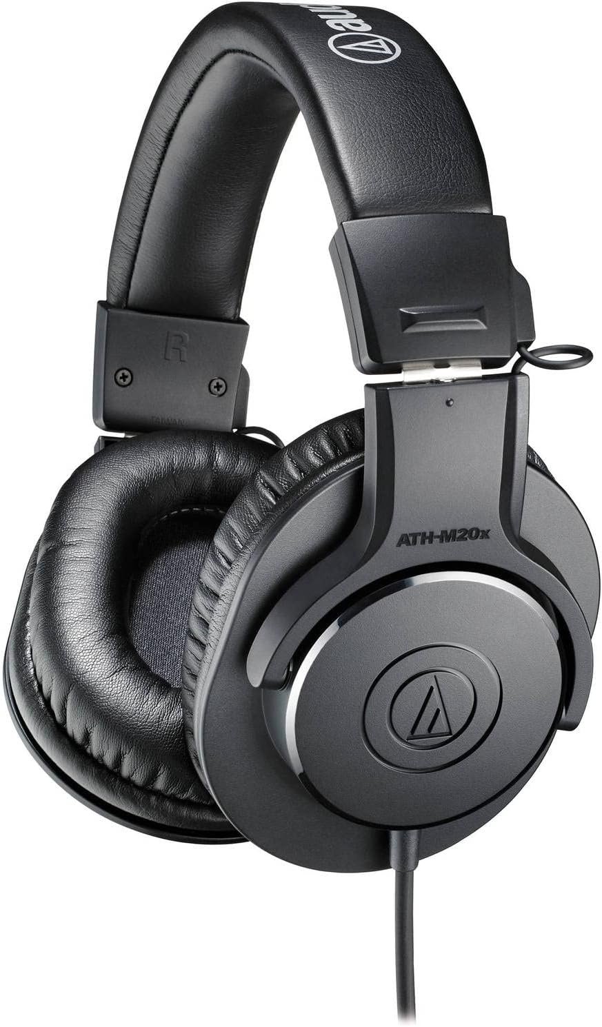 Audio-Technica ATH-M20X over-ear headphones with a sleek black design, featuring large padded ear cups and an adjustable headband, placed on a recording studio desk. The headphones highlight their professional-grade sound quality and superior sound isolation, ideal for monitoring and audio production.