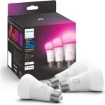 Philips Hue Smart Light bulb with a sleek frosted glass design, glowing in a soft white tone, installed in a modern living room lamp. The smart light is showcasing its ability to change colors and brightness, emphasizing compatibility with voice assistants like Alexa and Google Assistant for hands-free control.