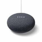 Google Nest Hub smart display with a sleek white frame and a 7-inch touchscreen, showing a home dashboard interface. It sits on a kitchen counter, blending with modern decor. The device provides voice control via Google Assistant, offering seamless integration with smart home devices and displaying personalized information like weather, calendars, and entertainment options.